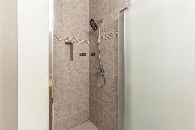 bathroom with tiled shower