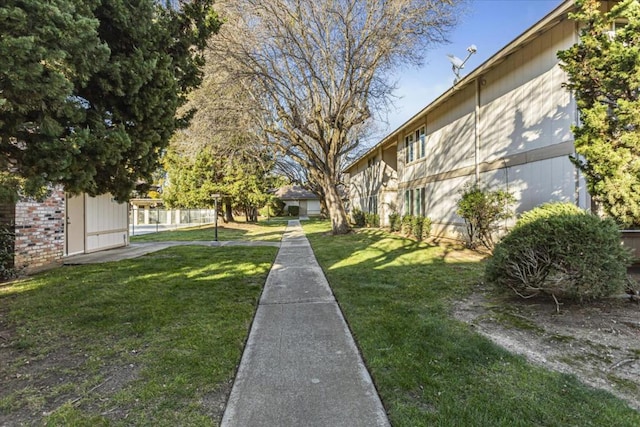 view of property's community with a lawn