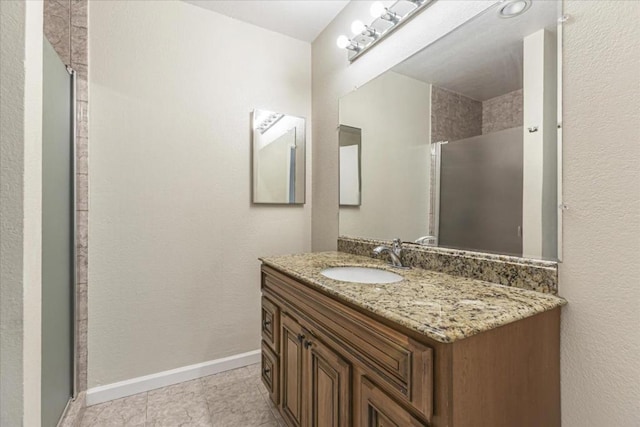 bathroom with vanity and a shower with door