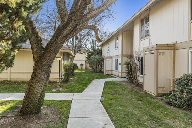 view of home's community with a lawn