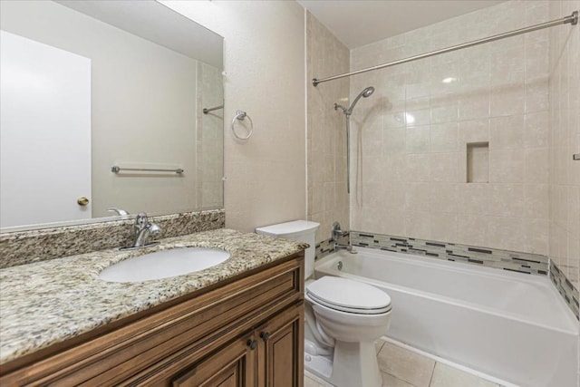 full bathroom with tile patterned floors, vanity, toilet, and tiled shower / bath combo