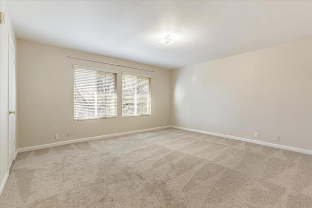 empty room featuring light colored carpet