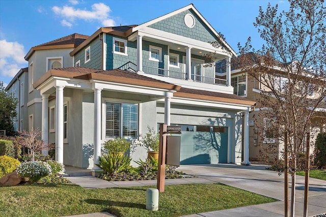 view of front facade with a balcony and a garage