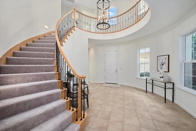 entryway with a high ceiling and an inviting chandelier