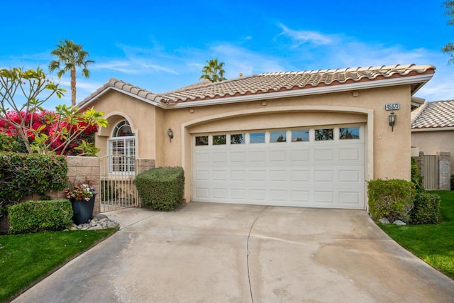 mediterranean / spanish home with a garage