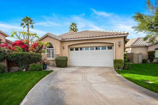 mediterranean / spanish house with a garage and a front yard