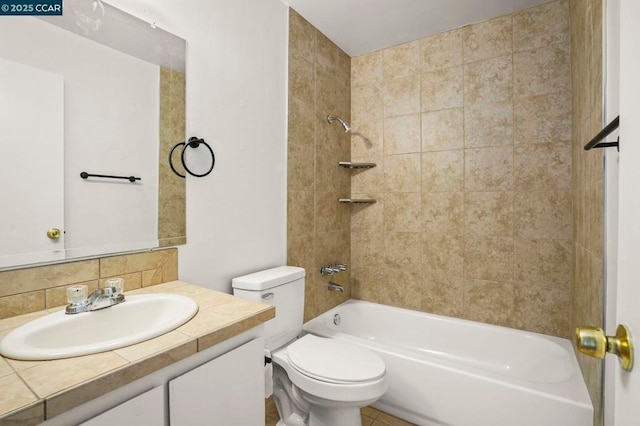 full bathroom with vanity, decorative backsplash, toilet, and tiled shower / bath