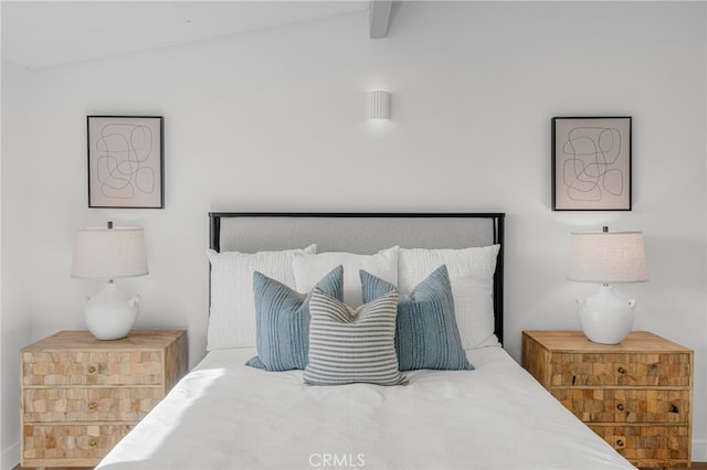 bedroom with vaulted ceiling with beams