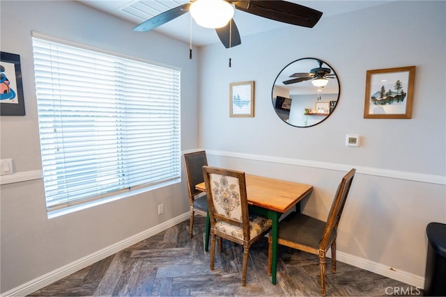 dining area with dark parquet floors and ceiling fan