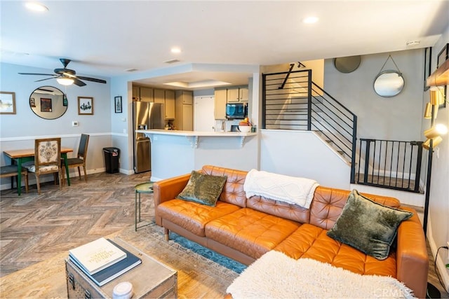 living room with parquet floors and ceiling fan