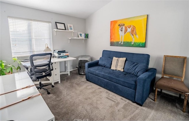 carpeted home office with vaulted ceiling