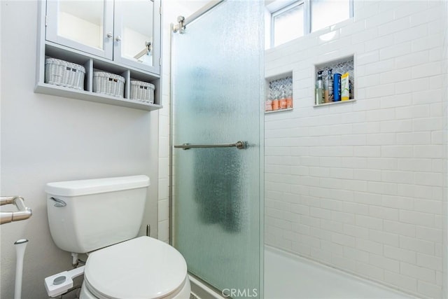 bathroom with toilet and an enclosed shower