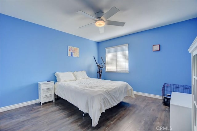 bedroom with dark hardwood / wood-style flooring and ceiling fan