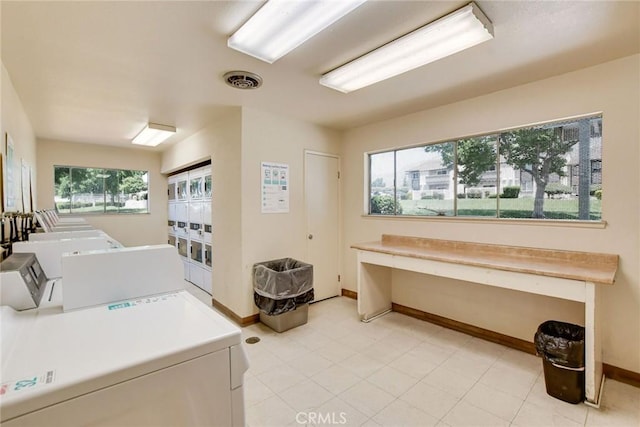 clothes washing area with a healthy amount of sunlight, stacked washer / dryer, and washing machine and dryer