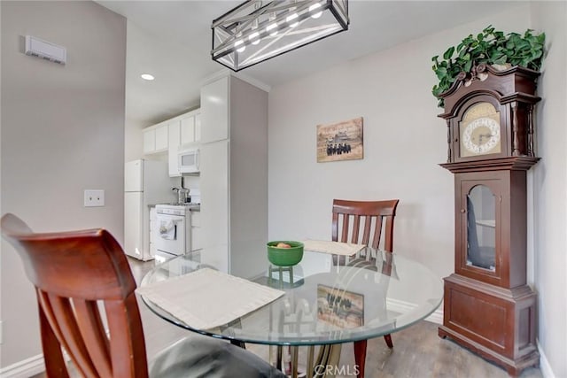 dining space with light hardwood / wood-style flooring