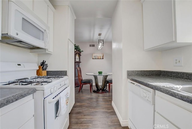 kitchen featuring dark wood-type flooring, white cabinets, and white appliances