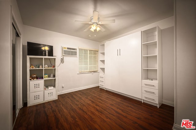 unfurnished bedroom with dark wood-type flooring, ceiling fan, and a wall mounted air conditioner