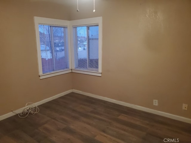 spare room with dark hardwood / wood-style flooring