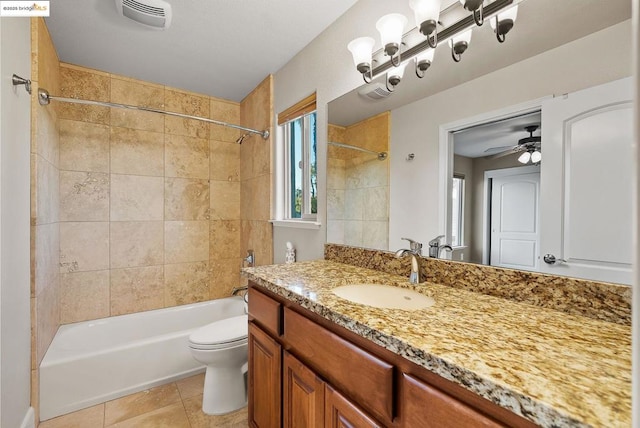 full bathroom featuring vanity, tiled shower / bath, tile patterned flooring, and toilet