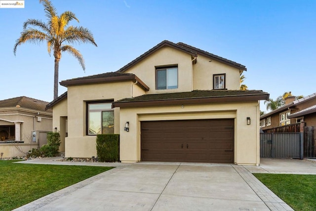 view of front of home featuring a garage and a front lawn