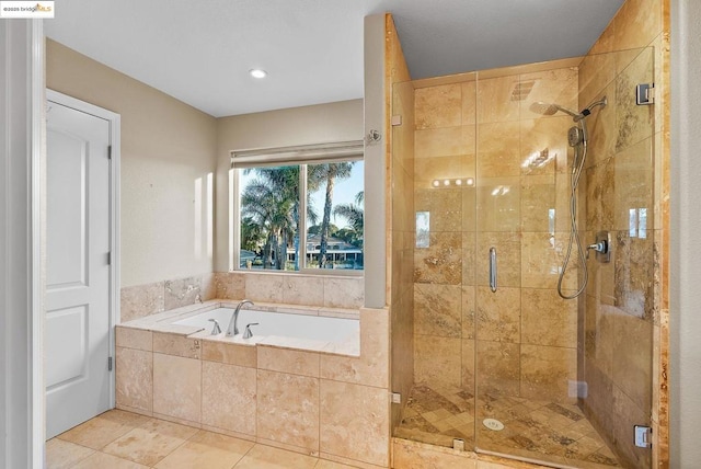 bathroom with separate shower and tub and tile patterned floors