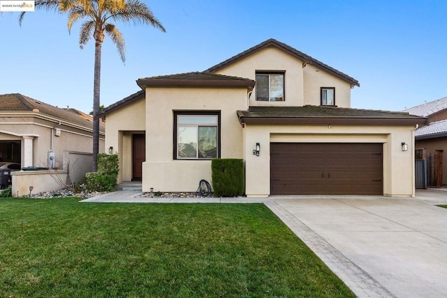 view of front of property featuring a garage and a front lawn