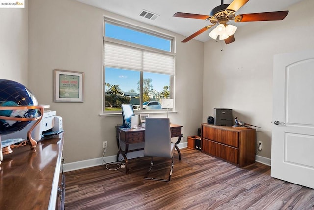 home office with ceiling fan and dark hardwood / wood-style flooring