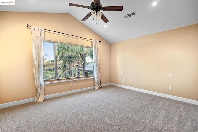 unfurnished room with vaulted ceiling, light colored carpet, and ceiling fan