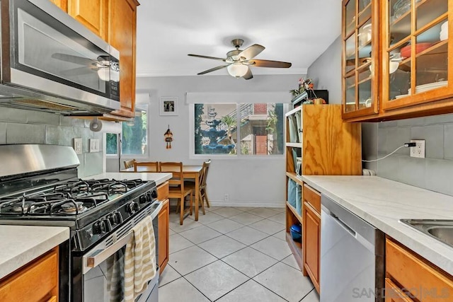 kitchen featuring appliances with stainless steel finishes, decorative backsplash, and a wealth of natural light