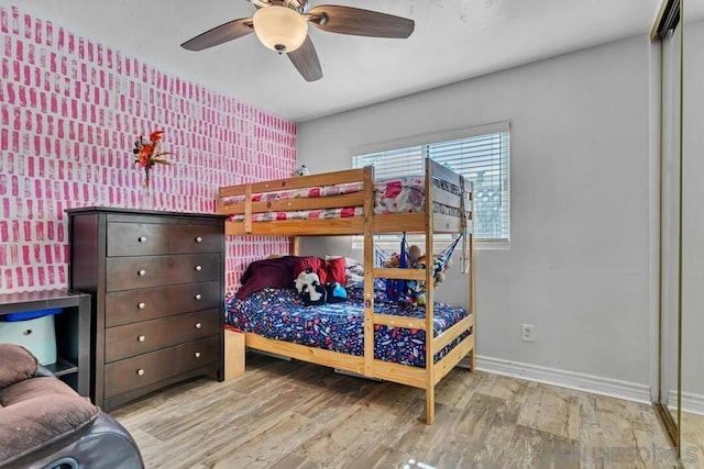 bedroom with ceiling fan and light hardwood / wood-style floors