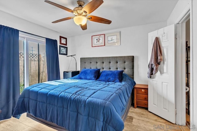 bedroom featuring multiple windows, ceiling fan, and light wood-type flooring