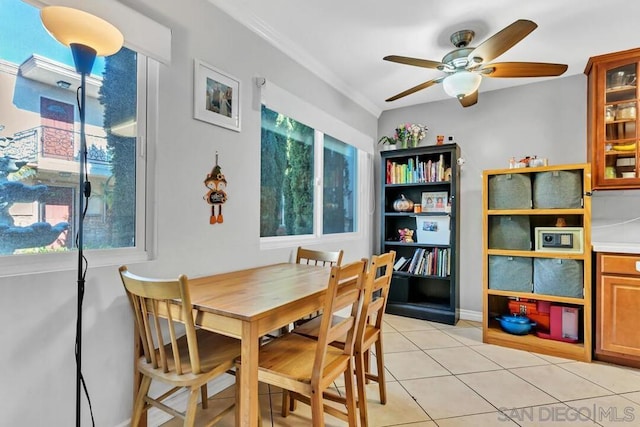 dining area featuring light tile patterned flooring, ornamental molding, and ceiling fan