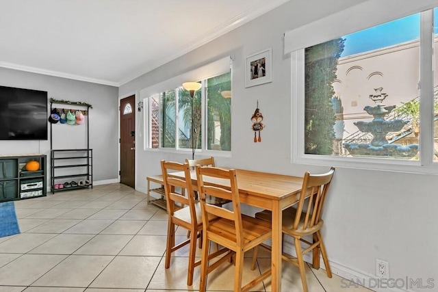 dining area featuring crown molding and light tile patterned flooring