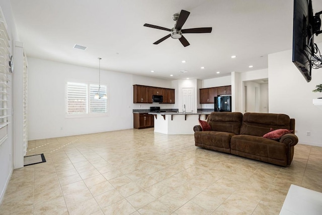 living room featuring sink and ceiling fan