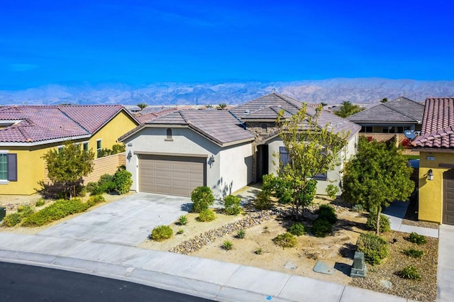 view of front of property featuring a garage and a mountain view