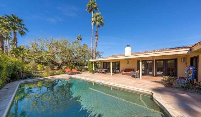 view of pool with an outdoor living space and a patio area