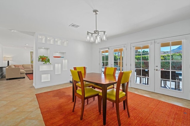 dining space featuring light tile patterned floors, plenty of natural light, and french doors