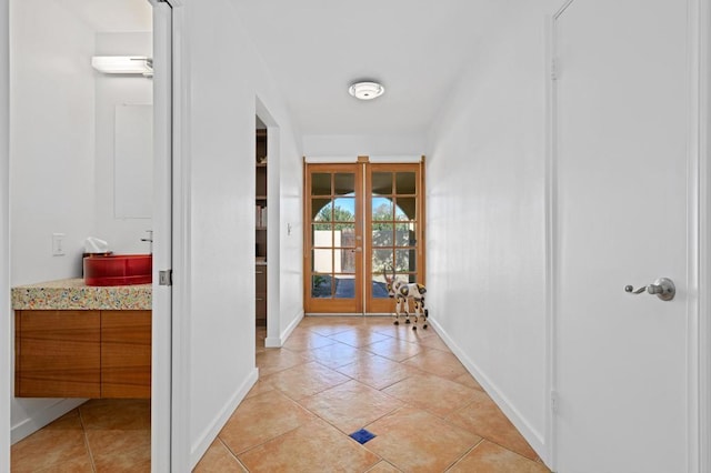 corridor featuring french doors and light tile patterned flooring