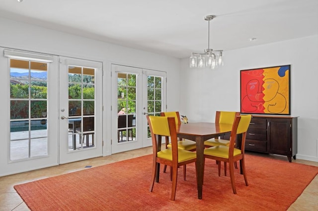 tiled dining space featuring french doors