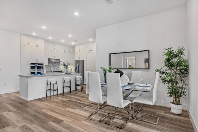 dining space featuring light hardwood / wood-style floors