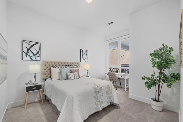 bedroom with light colored carpet