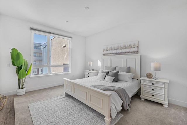 bedroom with multiple windows and light colored carpet