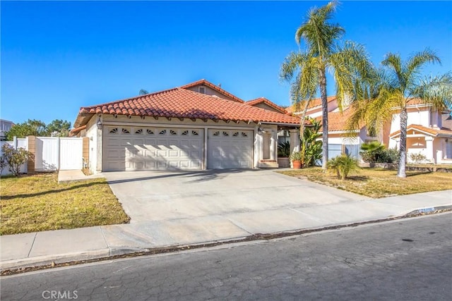 mediterranean / spanish-style home with a garage and a front yard