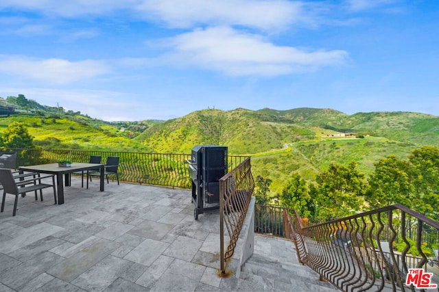 view of patio / terrace featuring a mountain view