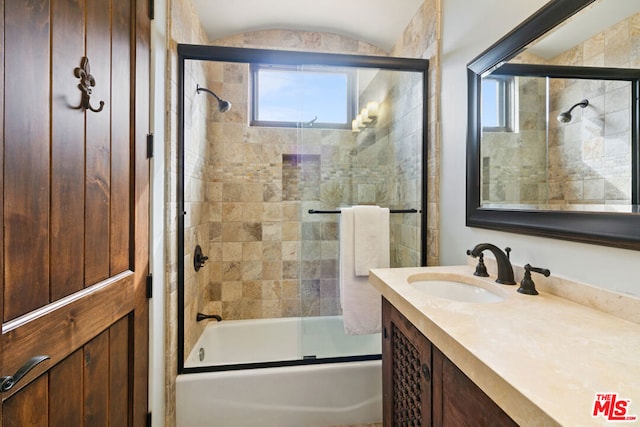 bathroom with bath / shower combo with glass door and vanity