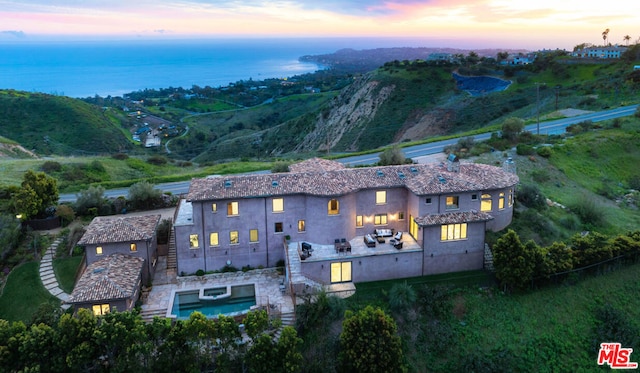 aerial view at dusk with a water view