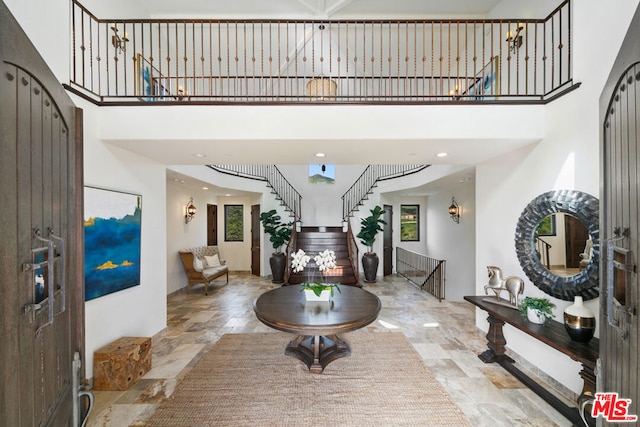 foyer entrance featuring a towering ceiling