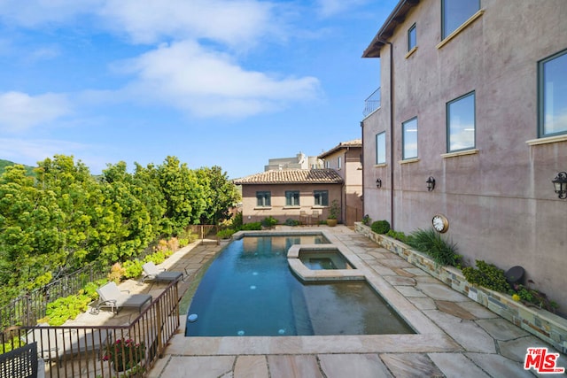 view of pool featuring an in ground hot tub and a patio area