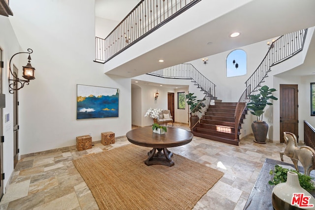 foyer featuring a towering ceiling