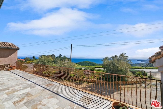 view of patio with a water view